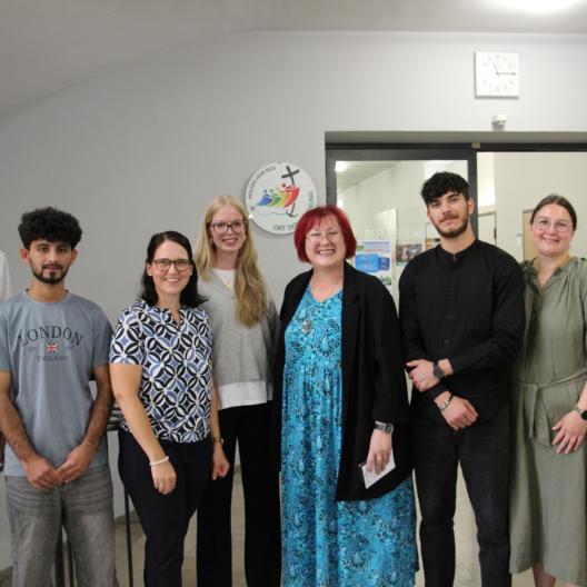Berufschule II. Schüler, Lehrer, Schulleitung und Pfarrer Markus Wolf (rechts) freuen sich über die Anerkennung